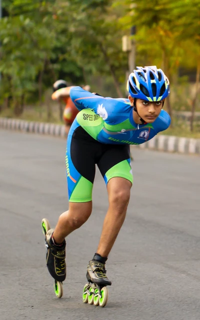 Feet of rollerblader wearing aggressive inline skates grinding on